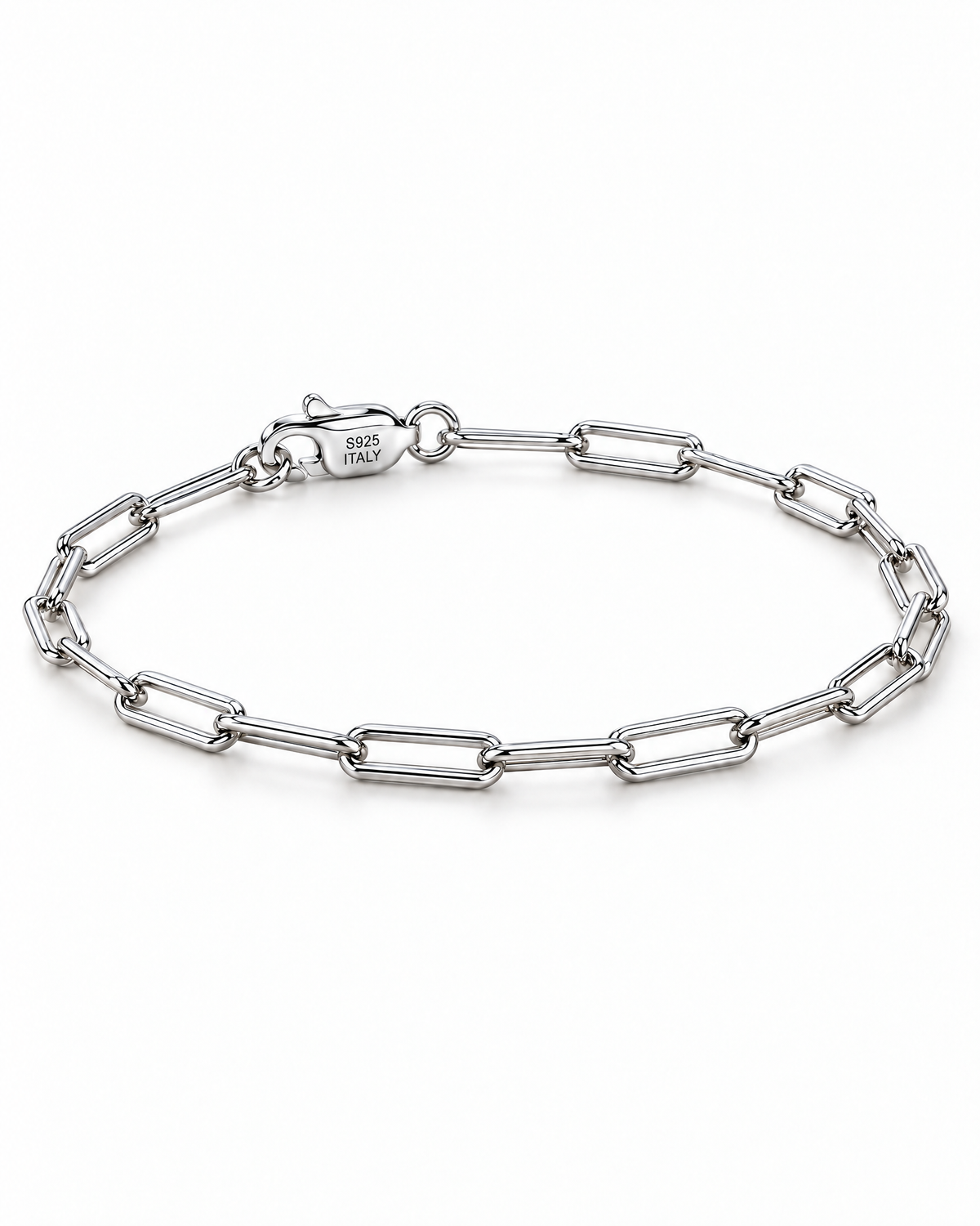 The Aelin Paperclip Bracelet in polished silver tone, low-angle complete oval resting view with the marked clasp toward the upper-left on a plain pearl-white studio surface; reference-based AI visualization