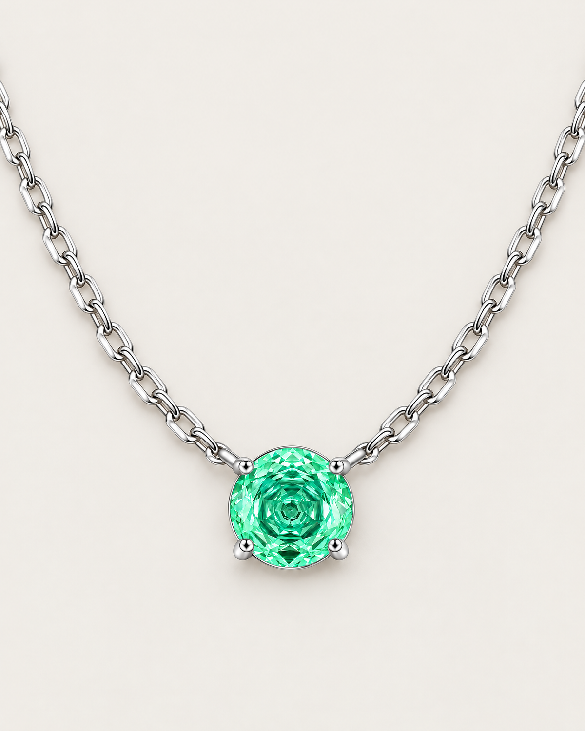 Round green faceted pendant in a silver-colored four-prong setting suspended from a wide linked-chain arc on pale greige — reference-based AI visualization