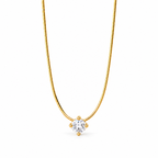 Gold-color segmented necklace in a centered open U with one clear round stone held by four rounded prongs on a pale warm greige studio surface; reference-based AI visualization.
