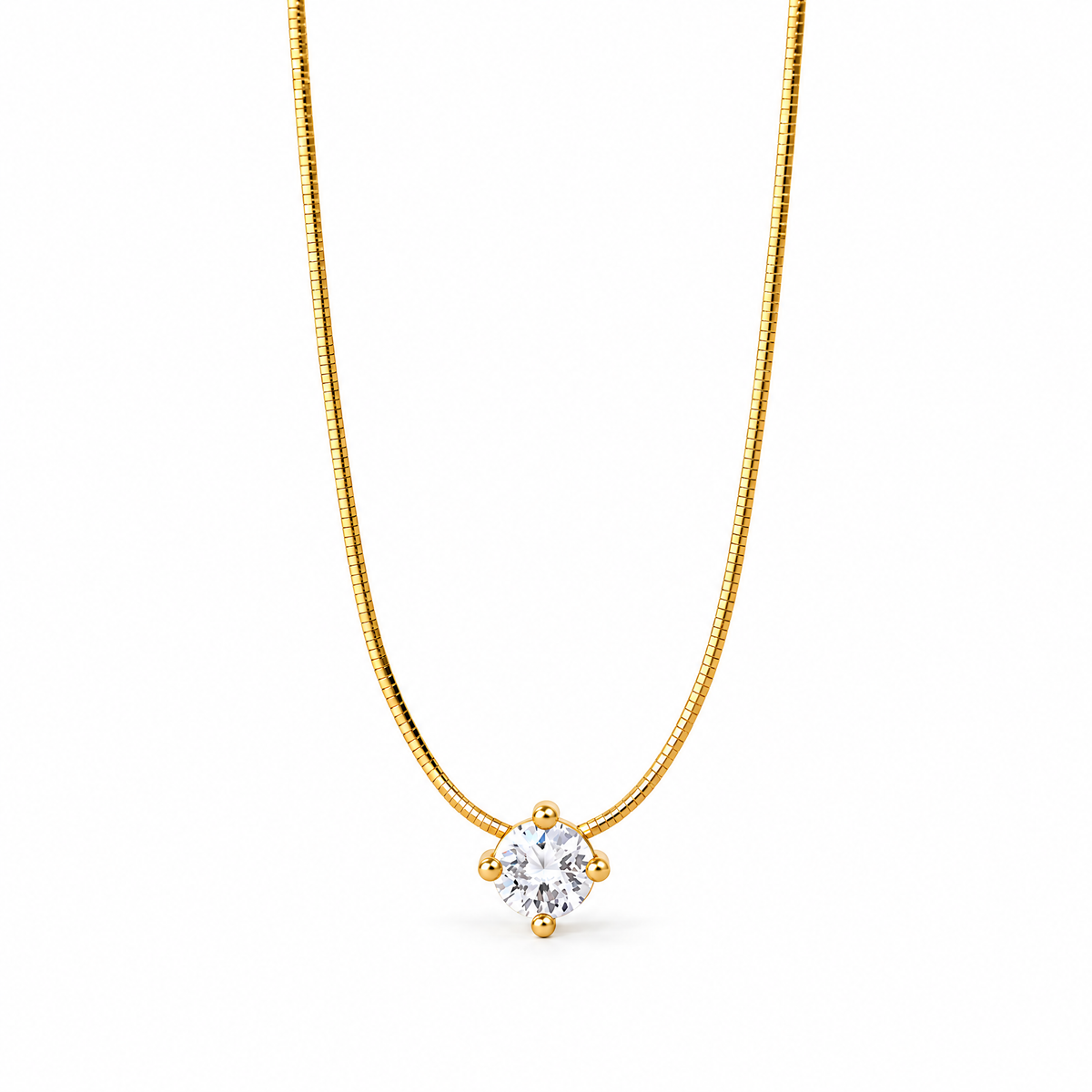Gold-color segmented necklace in a centered open U with one clear round stone held by four rounded prongs on a pale warm greige studio surface; reference-based AI visualization.