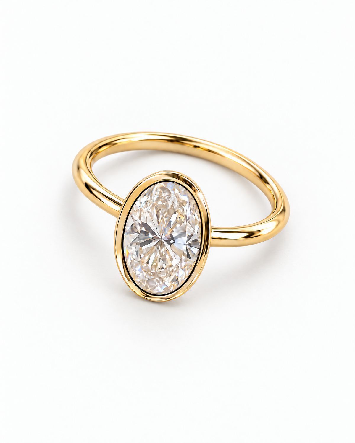 The Esme Bezel-Set Oval Ring in Gold Tone, complete overhead diagonal resting product-only view on a pearl-white studio background, reference-based AI visualization.