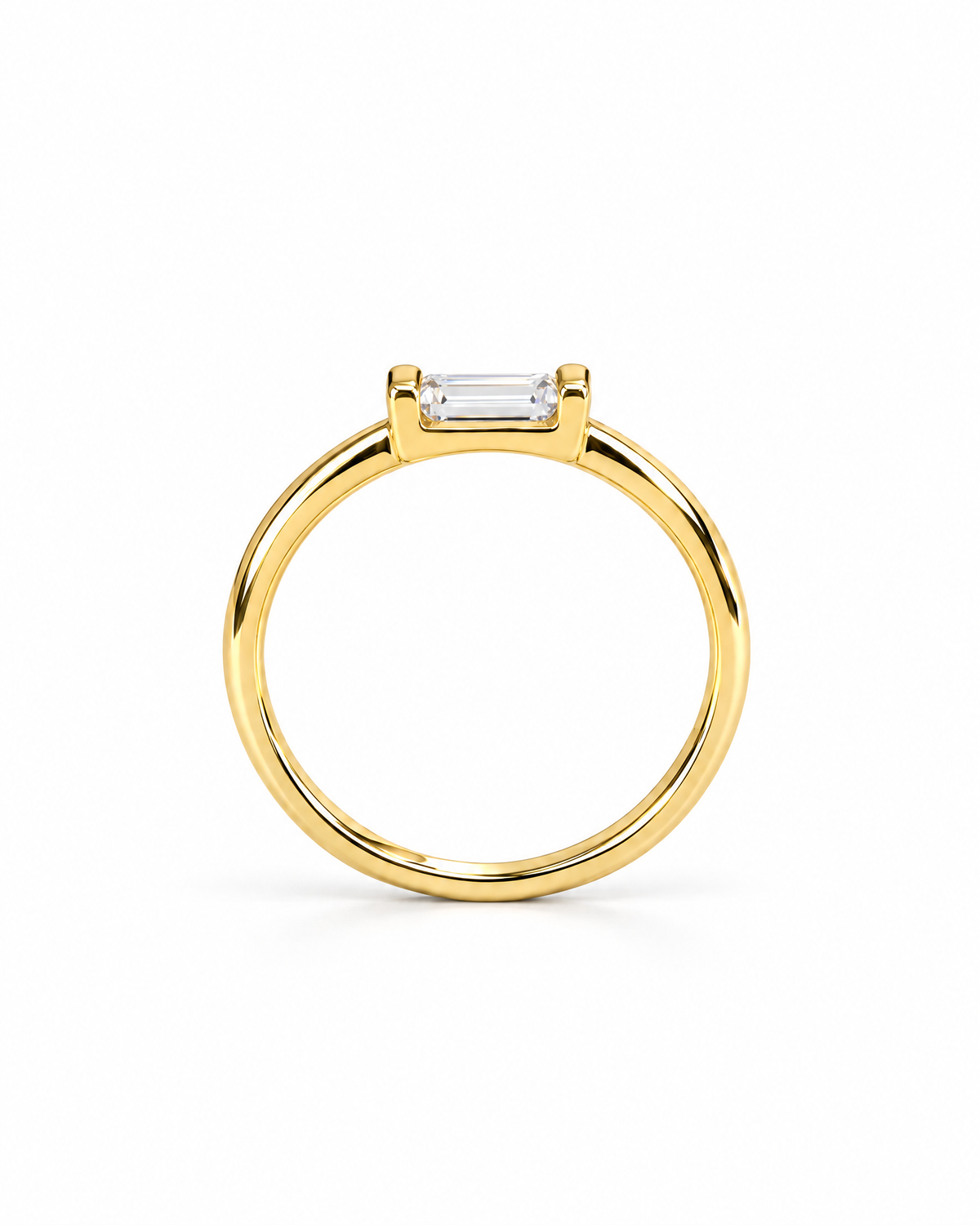 The Lyra CZ Emerald-Cut Statement Ring — gold-color upright front setting angle with a clear emerald-cut center stone on a pearl-white studio background; reference-based AI visualization.