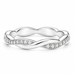 The Veda CZ Twisted Band — polished silver twisted band with clear round CZ accents, face-up resting full-ring view on pearl-white studio background; reference-based AI visualization.