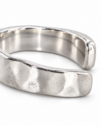 The Lena Hammered Open Band Ring — polished silver-tone hammered exterior and rounded open-end macro on a pearl-white studio background, reference-based AI visualization.