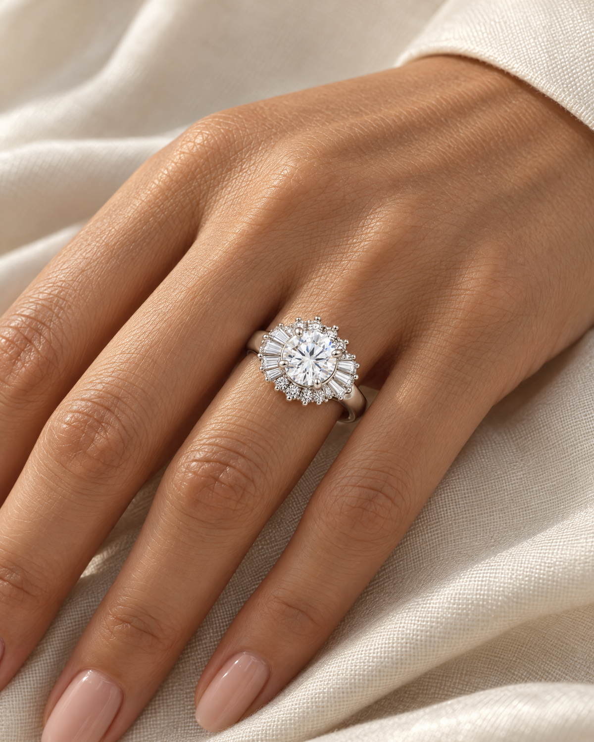 The Elian CZ Baguette Ring in polished silver-toned finish worn on a medium-warm skin-tone hand over ivory linen — reference-based AI visualization.