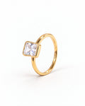 The gold-finish Eira Square Solitaire Ring shown complete from a left-facing three-quarter setting-profile angle on pearl white, with the source-observed S925 interior marking; reference-based AI visualization.