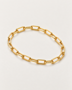 The Linnea Link Bracelet — polished gold-color paperclip-link overhead resting lay on pale greige — reference-based AI visualization