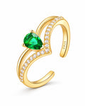 The Tuva Green Pear Wrap Ring in polished gold-color metal with a green pear-shaped stone and clear round accents, upright product-only on a pearl-white studio background, reference-based AI visualization