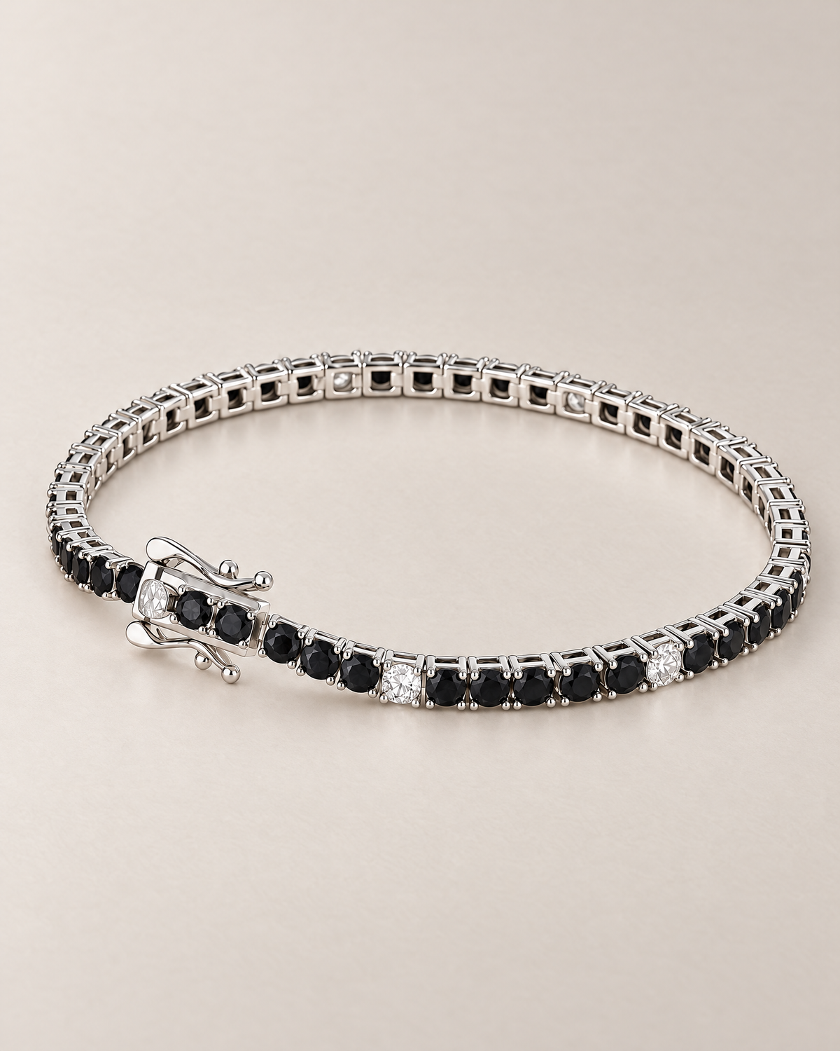 The Signe Black & White CZ Tennis Bracelet in polished silver-tone metal, shown with its open box clasp, curved safety catches, and repeating black and clear/white round stones on pale greige, reference-based AI visualization.
