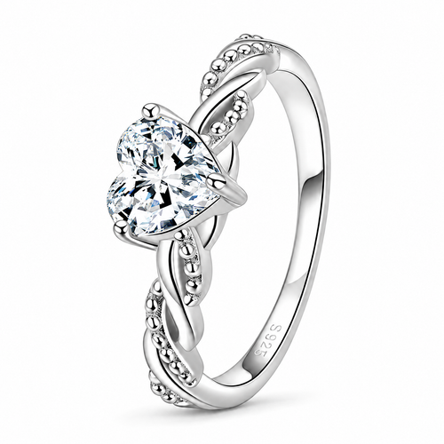 The Alva Heart-Stone Ring, observed polished silver-tone, complete front three-quarter product-only view with a clear heart-shaped center stone, four rounded prongs, and twisted beaded shoulders on a pearl-white studio background — reference-based AI visualization.
