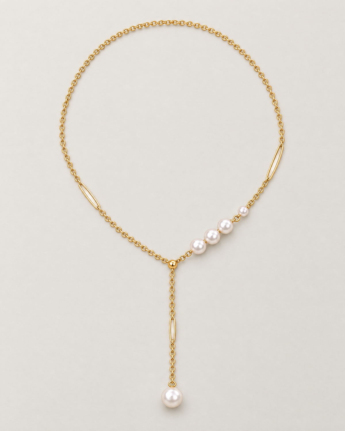 The Freya Pearl Drop Necklace — warm gold-tone cable chain in an organic oval lay with asymmetric white pearl-like accent beads and a single pearl-like drop on pale greige, reference-based AI visualization