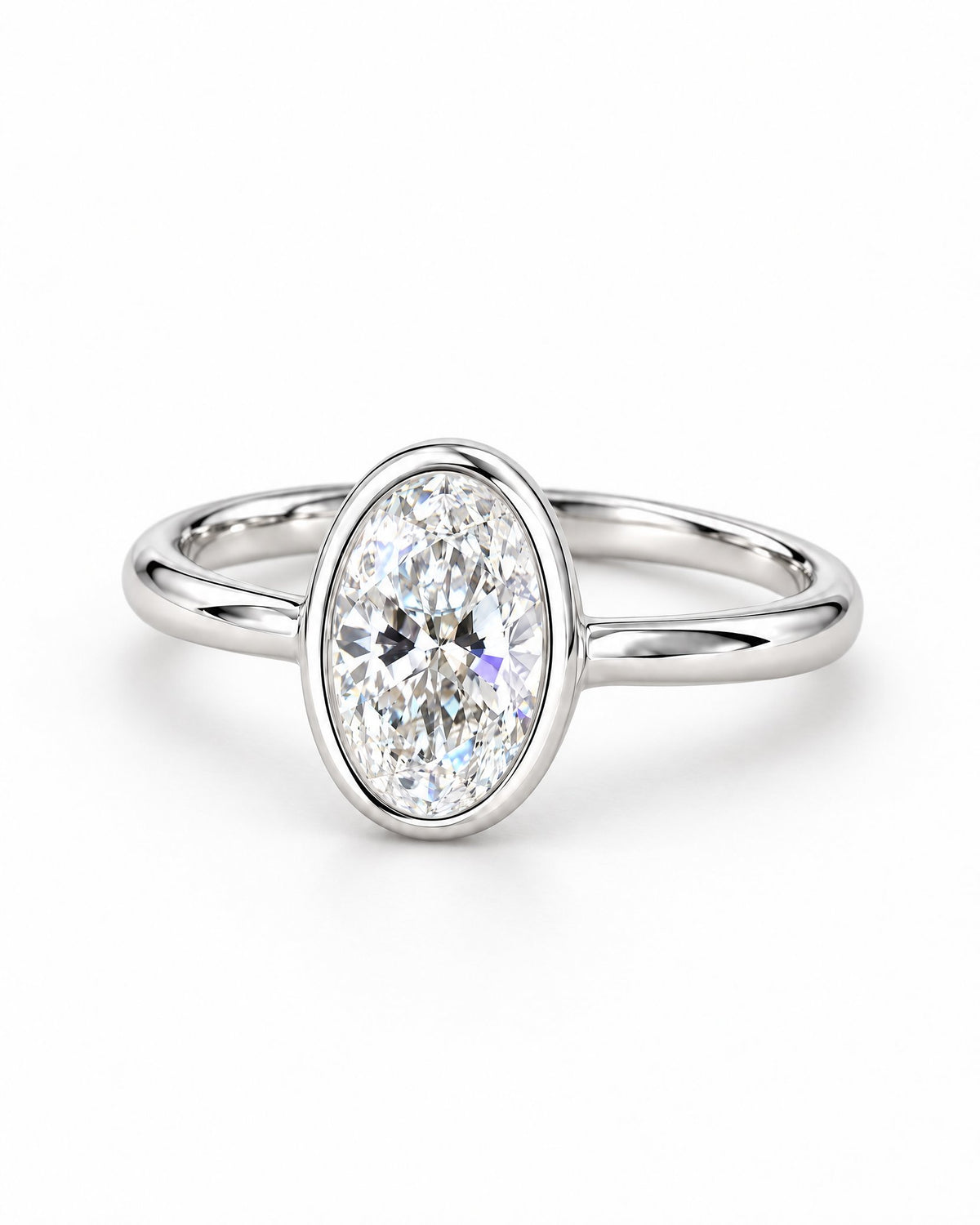 The Esme Bezel-Set Oval Ring in Sterling Silver, shallow three-quarter setting-profile product-only view on a pearl-white studio background, reference-based AI visualization.
