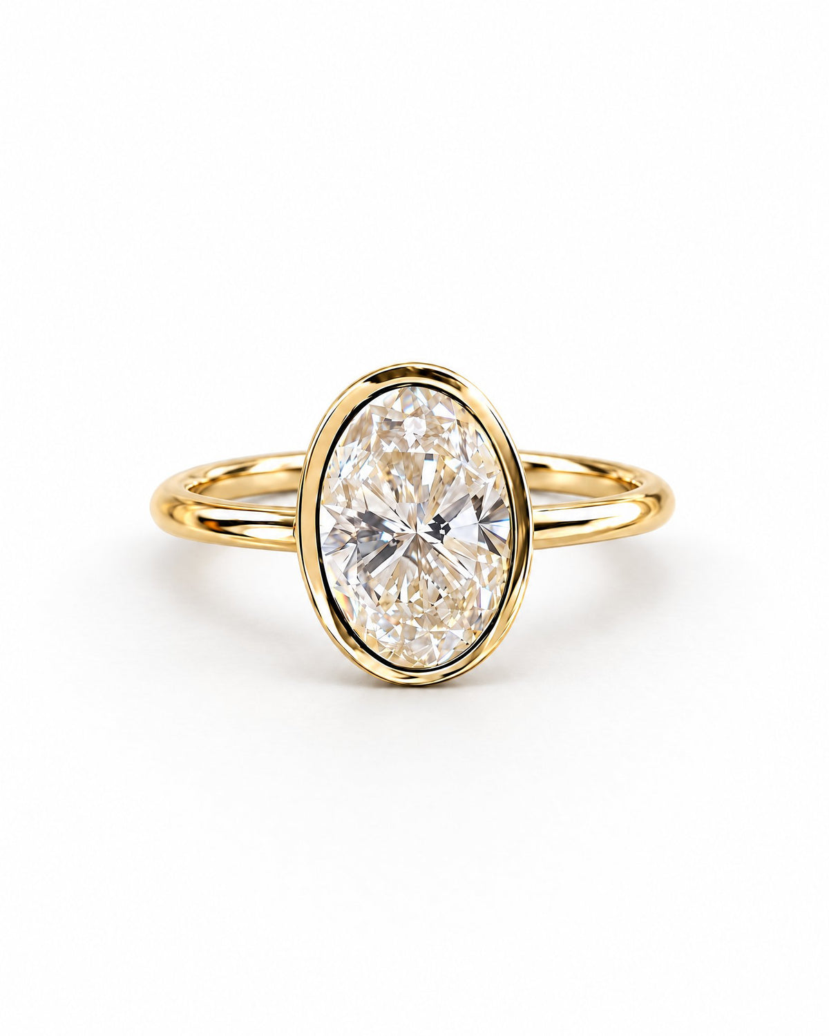 The Esme Bezel-Set Oval Ring in Gold Tone, complete front three-quarter product-only hero on a pearl-white studio background, reference-based AI visualization.