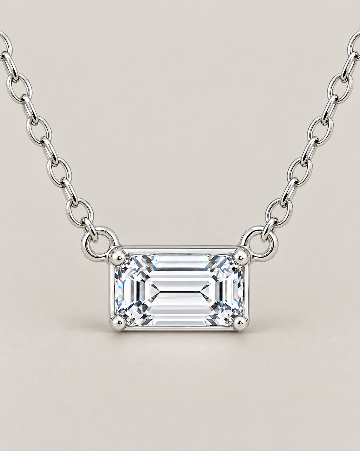 The Mara Geometric CZ Pendant — jewelry-only straight-on detail of the horizontal clear rectangular stone, four corner prongs, side rings, and short alternating-link chain sections on pale warm greige; reference-based AI visualization