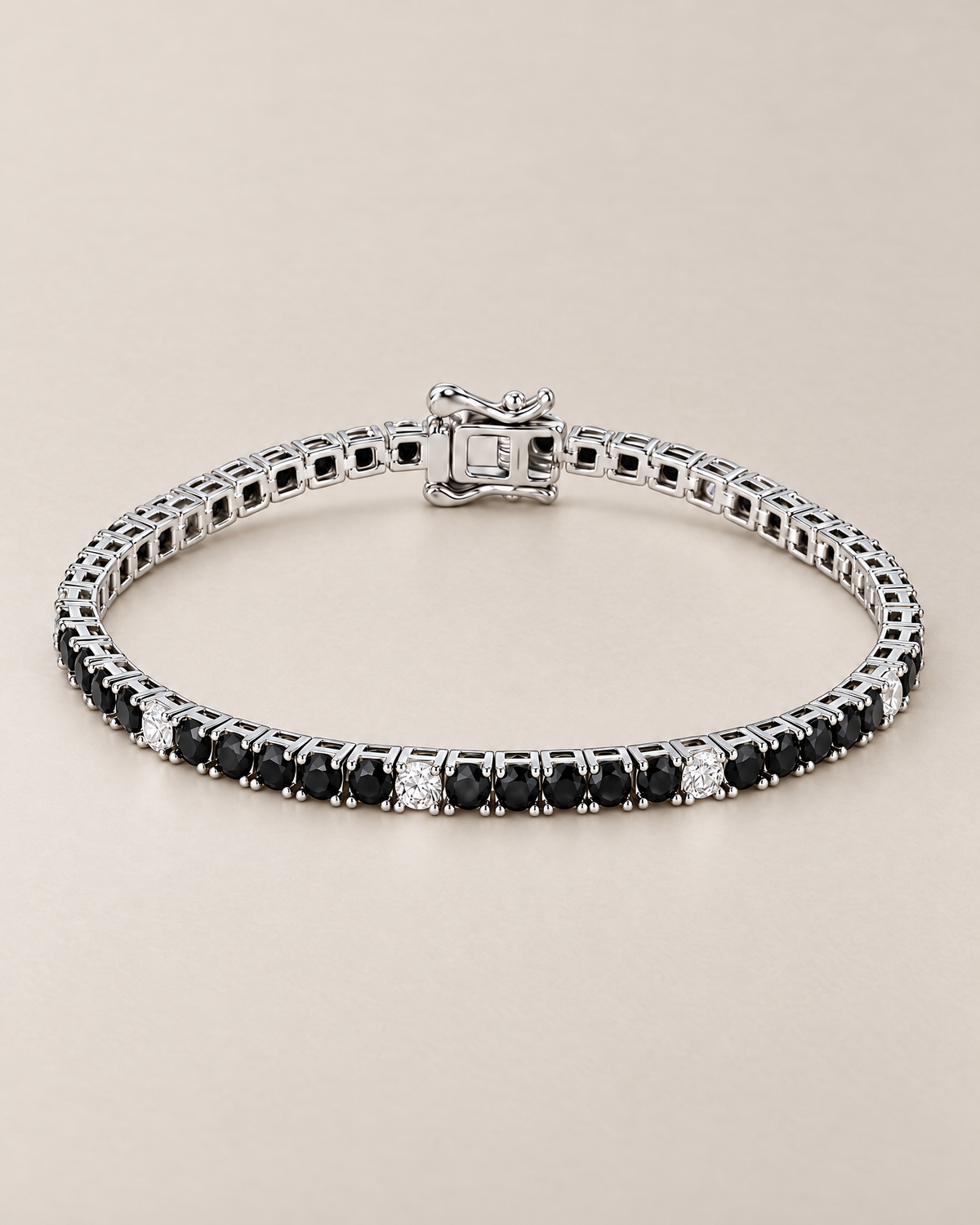 The Signe Black & White CZ Tennis Bracelet in polished silver-tone metal, shown as a full oval with repeating black and clear/white round stones and a box clasp on pale greige, reference-based AI visualization.