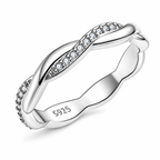 The Veda CZ Twisted Band — polished silver twisted band with clear round CZ accents, front three-quarter product-only hero on pearl-white studio background; reference-based AI visualization.