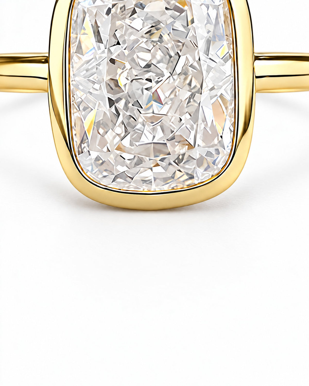 The Tilde Bezel Ring in polished yellow-gold tone with one clear faceted rounded-rectangle stone in a lower bezel detail macro on pearl-white — reference-based AI visualization
