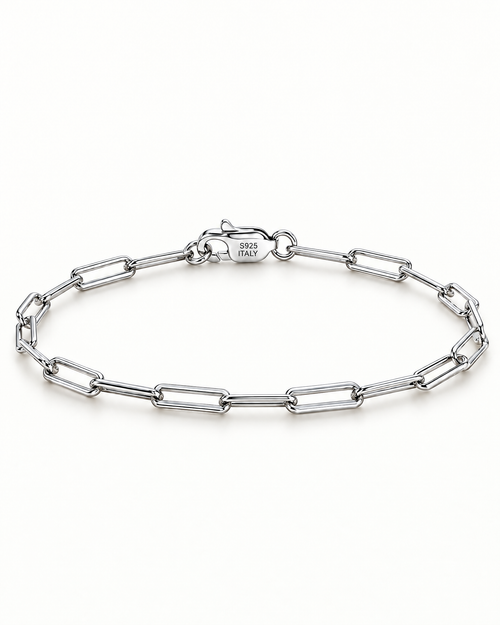 The Aelin Paperclip Bracelet in silver tone, full oval hero on a plain pearl-white studio background; reference-based AI visualization