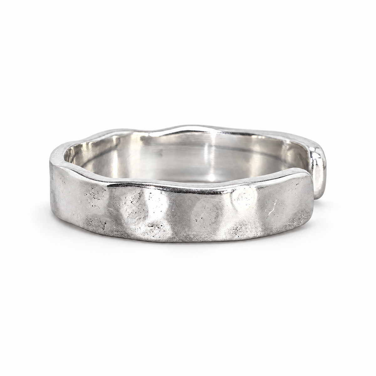The Lena Hammered Open Band Ring — polished silver-tone front three-quarter product-only hero on a pearl-white studio background, reference-based AI visualization.