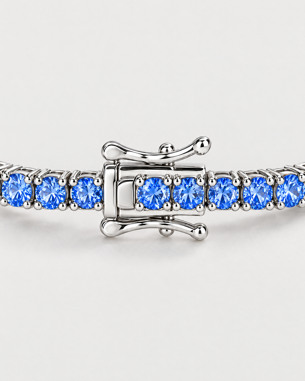 The Orla CZ Tennis Bracelet — closed silver-tone clasp with adjacent blue four-prong settings on pale greige — reference-based AI visualization