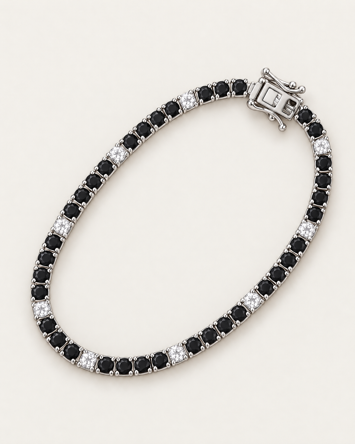 The Signe Black & White CZ Tennis Bracelet in polished silver-tone metal, arranged in an overhead diagonal oval with repeating black and clear/white round stones on pale greige, reference-based AI visualization.