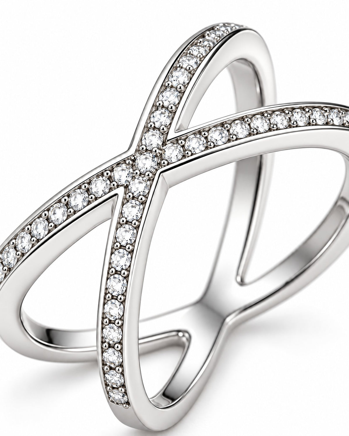The Elsen Geometric Ring in a polished silver-tone finish with clear round stones, close crossover-setting macro detail on a pearl-white studio background, reference-based AI visualization