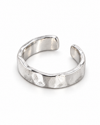 The Lena Hammered Open Band Ring — polished silver-tone face-up open-band resting view on a pearl-white studio background, reference-based AI visualization.