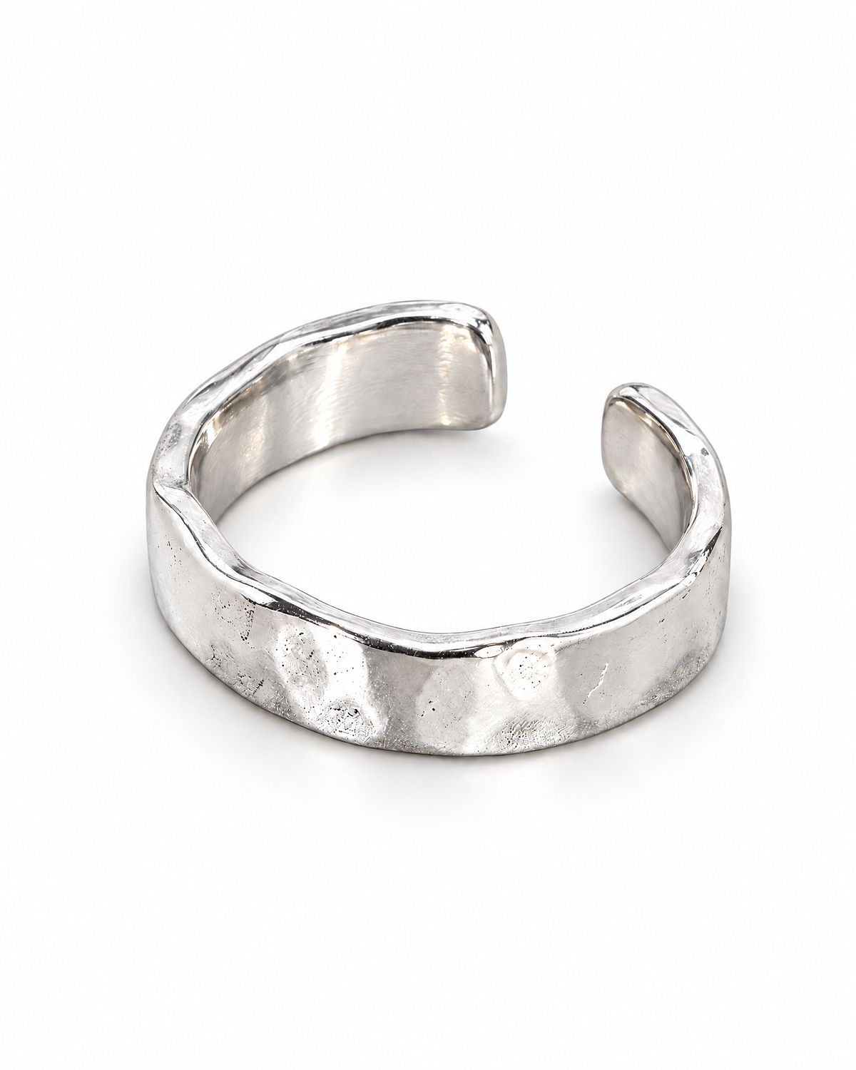 The Lena Hammered Open Band Ring — polished silver-tone face-up open-band resting view on a pearl-white studio background, reference-based AI visualization.