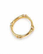 The Ebba Bamboo Band in polished yellow-gold color with clear round stone accents, overhead product-only studio view on a pearl-white background; reference-based AI visualization.