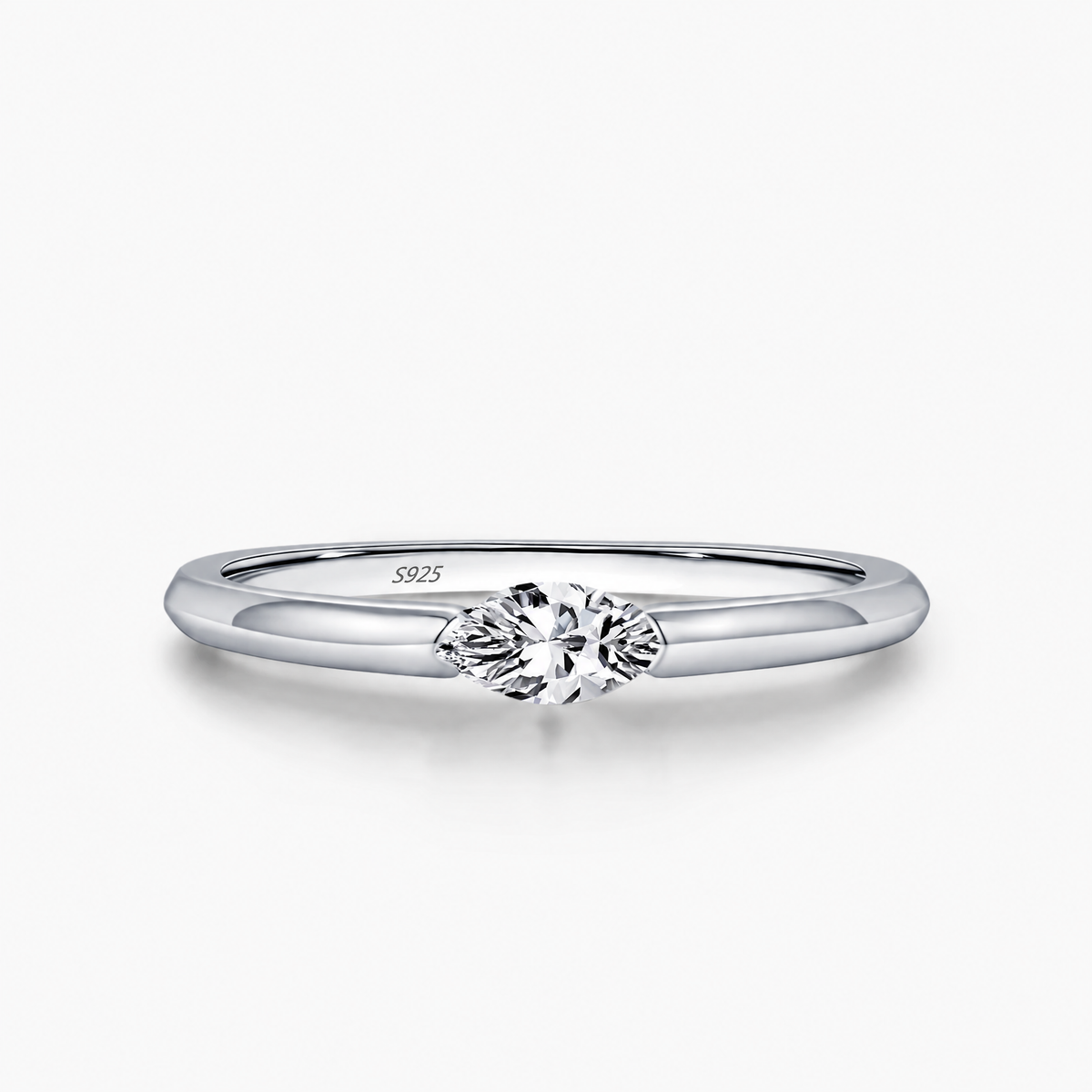 The Aure Marquise-Cut CZ Ring, polished silver marquise setting and tapered-shoulder detail on a pearl-white studio background — reference-based AI visualization.