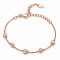 The Dahlia S925 Heart Bracelet in warm rose-gold-toned metal with five alternating clear heart and round stone stations in a full front oval on pale greige, reference-based AI visualization.