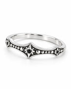 The Runa Starburst Ring — bright silver-tone finish, low three-quarter complete-ring view on a pearl-white studio background; reference-based AI visualization.
