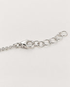The Sora Halo Bracelet polished cool silver-tone lobster-style clasp with fine round-link chain and adjustable open oval-link extension on pale greige reference-based AI visualization