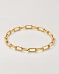 The Linnea Link Bracelet — polished gold-color rounded paperclip-link oval on pale greige — reference-based AI visualization