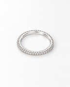 The Vale CZ Eternity Band — bright polished silver-tone clear-stone eternity band in a face-up overhead resting view on a pearl-white studio background, reference-based AI visualization