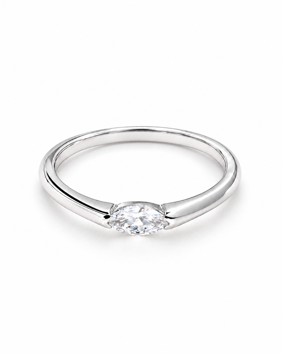 The Aure Marquise-Cut CZ Ring, polished silver front three-quarter product-only hero on a pearl-white studio background — reference-based AI visualization.