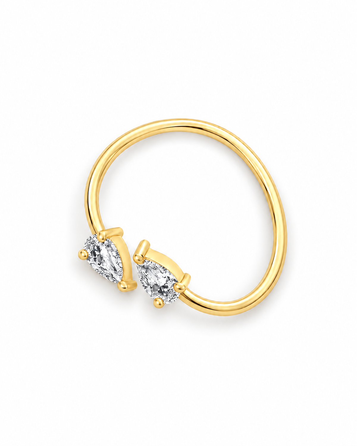 The Agnes Twin-Pear Ring in a polished yellow-gold finish with two clear pear-shaped stones, rotated whole-ring overhead view on a pearl-white studio background — reference-based AI visualization