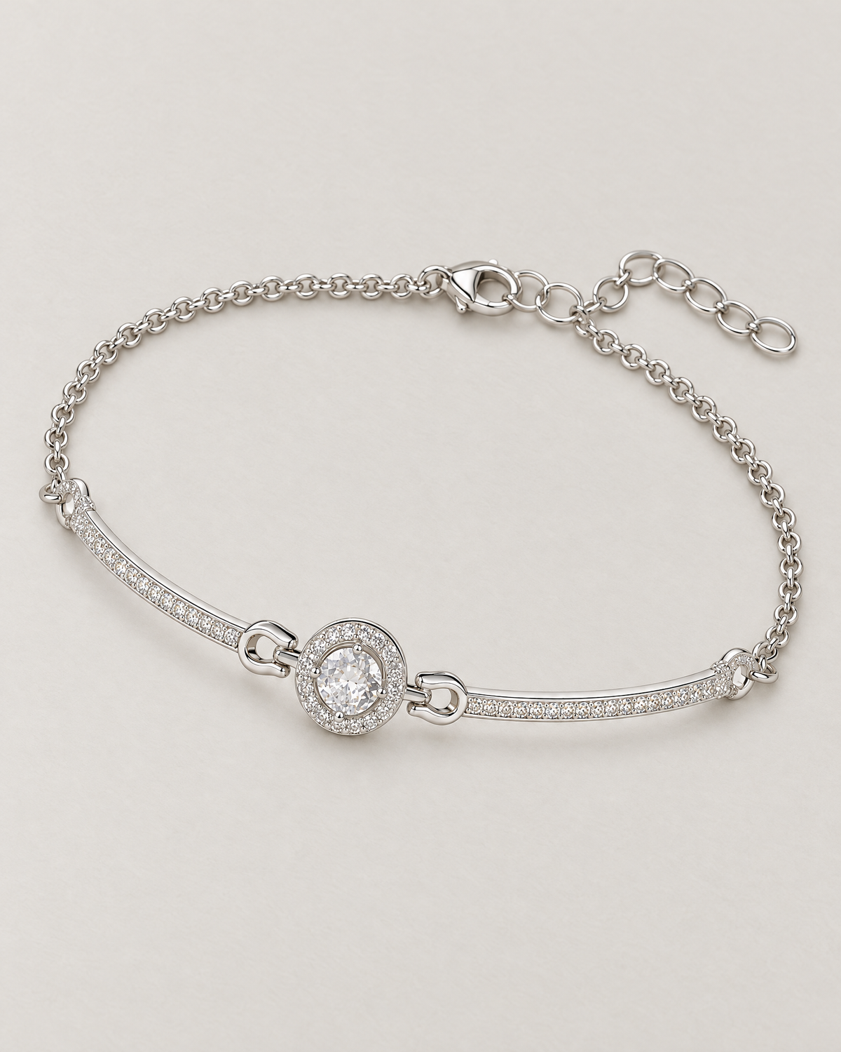 The Sora Halo Bracelet polished cool silver-tone complete diagonal overhead lay with clear-stone halo, curved stone-set bars and chain extension on pale greige reference-based AI visualization