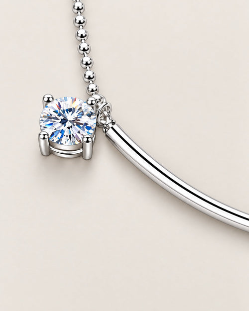 The Eden Moissanite Bracelet polished silver-tone curved bar and one round clear four-prong stone detail on a pale-greige background, reference-based AI visualization.