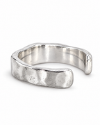 The Lena Hammered Open Band Ring — polished silver-tone left side and open-end profile on a pearl-white studio background, reference-based AI visualization.