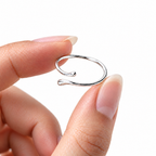 The Nova Open Geometric Band — polished silver-tone low resting open-gap product view on a pearl-white studio background; reference-based AI visualization.