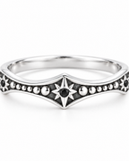 The Runa Starburst Ring — bright silver-tone central starburst and dark accent detail on a pearl-white studio background; reference-based AI visualization.
