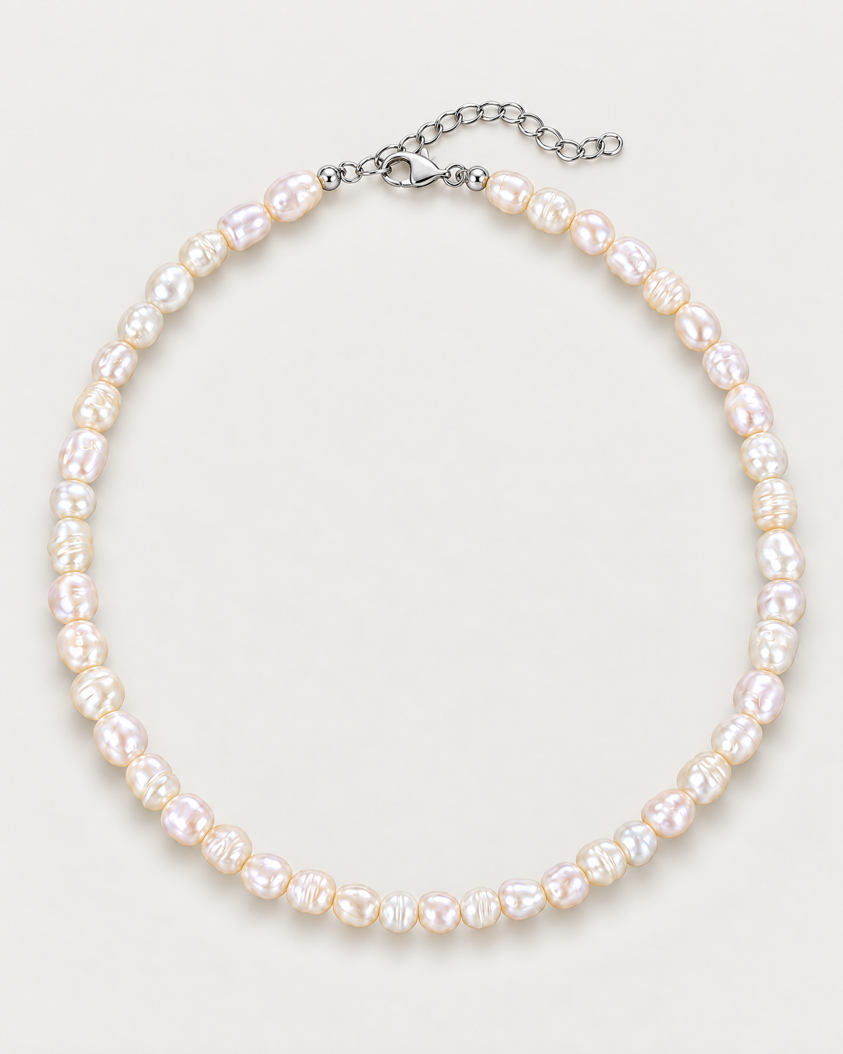 Irregular off-white pearl strand arranged as a complete overhead oval with visible clasp and extension on a pale greige studio surface; reference-based AI visualization