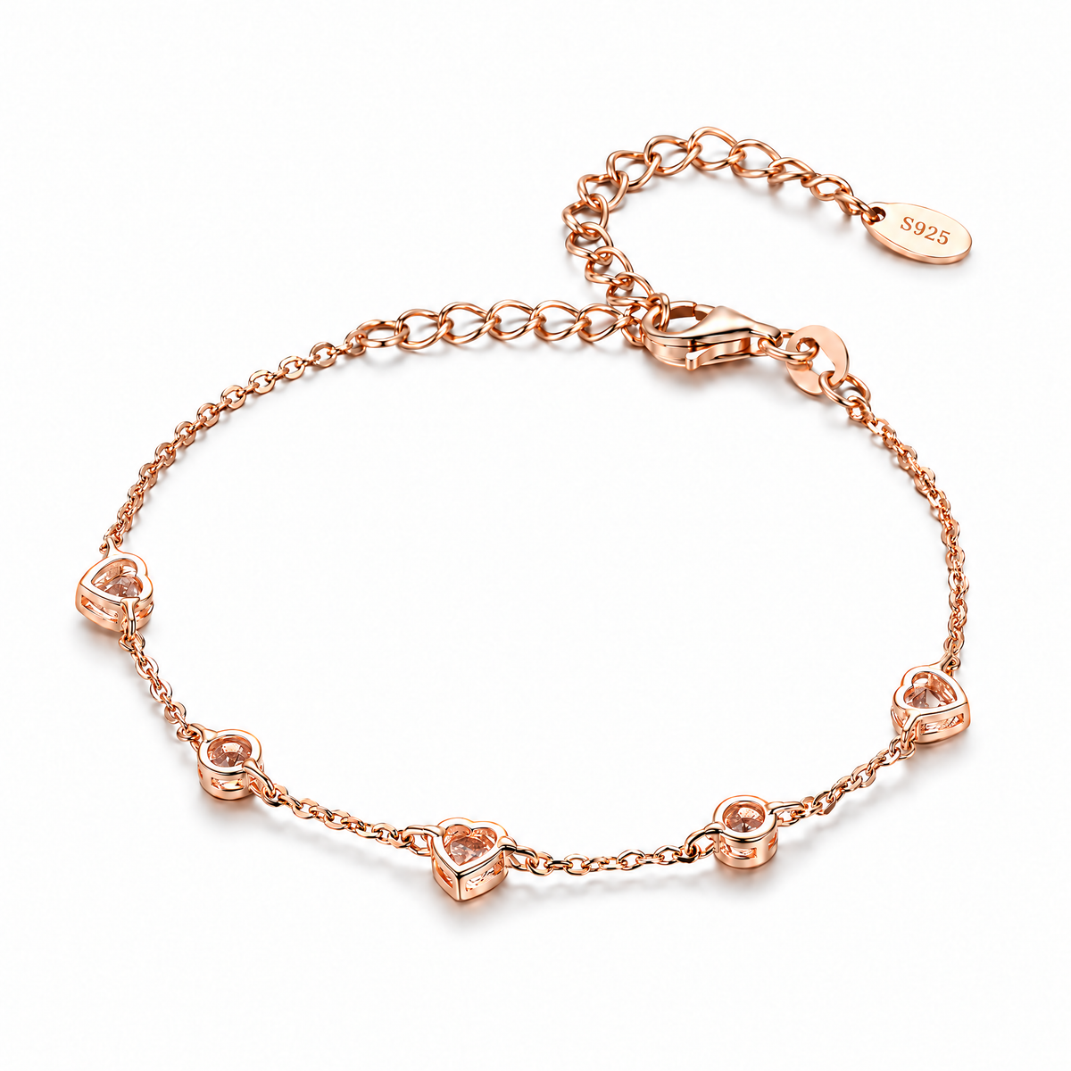 The Dahlia S925 Heart Bracelet in warm rose-gold-toned metal, shown from the open-backed side with five alternating heart and round stations in an oval on pale greige, reference-based AI visualization.