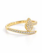 The Oona Pavé Teardrop Ring in warm polished gold with clear round pavé stones, complete left-side setting-depth view on a pearl-white studio background; reference-based AI visualization.