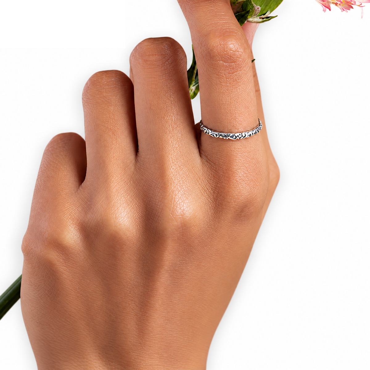 The Svea Engraved Vine Band in silver-tone finish, complete low lateral profile showing its raised vine scrollwork — reference-based AI visualization.